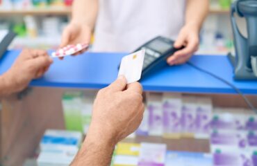 Customer paying for pills using credit card.