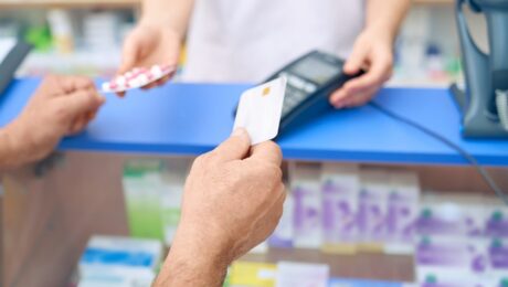 Customer paying for pills using credit card.